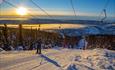 From the drag lift at Valdres Alpinsenter i Aurdal there's a stunning view. Here the evening sun lights up the scene.