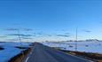 Road over mountain plateau with snow in the Blue Hour.