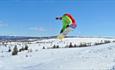 Person jumping on a snowboard