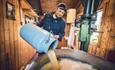 Man pouring milk in a giant pot
