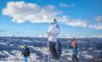 Alpine skiers with a far view at Valdres Alpinsenter in Aurdal.