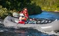 Eine Frau in einem Packraft in einem Fluss
