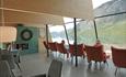 Beautiful view of the Gjende from inside of the Café. In the picture you can also see comfortable chairs to sit in.