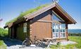 Hütte mit Grasdack und einem Fahrrad vor der Tür