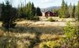 Idyllic mountain farming landscape at Veneli with a red farm hut.