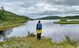 A person in front og a mountain lake