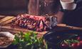 Beautifully presented sliced meat with a sprinkle of salt