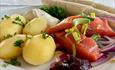 Rakfisk plate with boiled potatoes, semi-fermented trout and sides