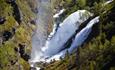 A double waterfall and a river at the bottom of a gorge.