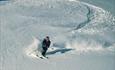 Off-piste skiing pleasure in powder snow down the slopes of Stølsnøse.