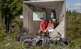 Cyclists take a break to check their position on the map in a specially designed rest shelter along the Mjølkevegen cycling route at Furuset.