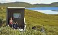 Cyclists enjoy a break in a rest shelter along Jotunheimvegen.