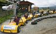 Go-carts with drivers wait in line for the lift.