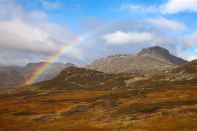 The mountain Bitihorn behind a rainbow