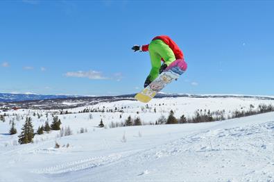 Person jumping on a snowboard