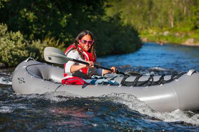 Lady in a pack raft in a river