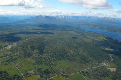 Aerial view of Golsfjellet showing large parts of the mountain road that leads around it. The cycling tour "Golsfjellet rundt" follows this road.