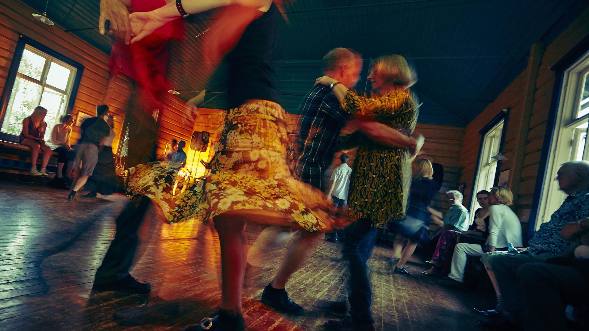 People swirl around dancing during a warm summer night