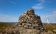 Large, solid summit cairn with an integrated bench of rocks on Smørlifjellet.