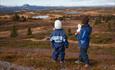 Two children in the heather in open high country