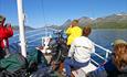 Sailing on M/B Bitihorn across Lake Bygdin, blue skies and 2000m-summits in the background