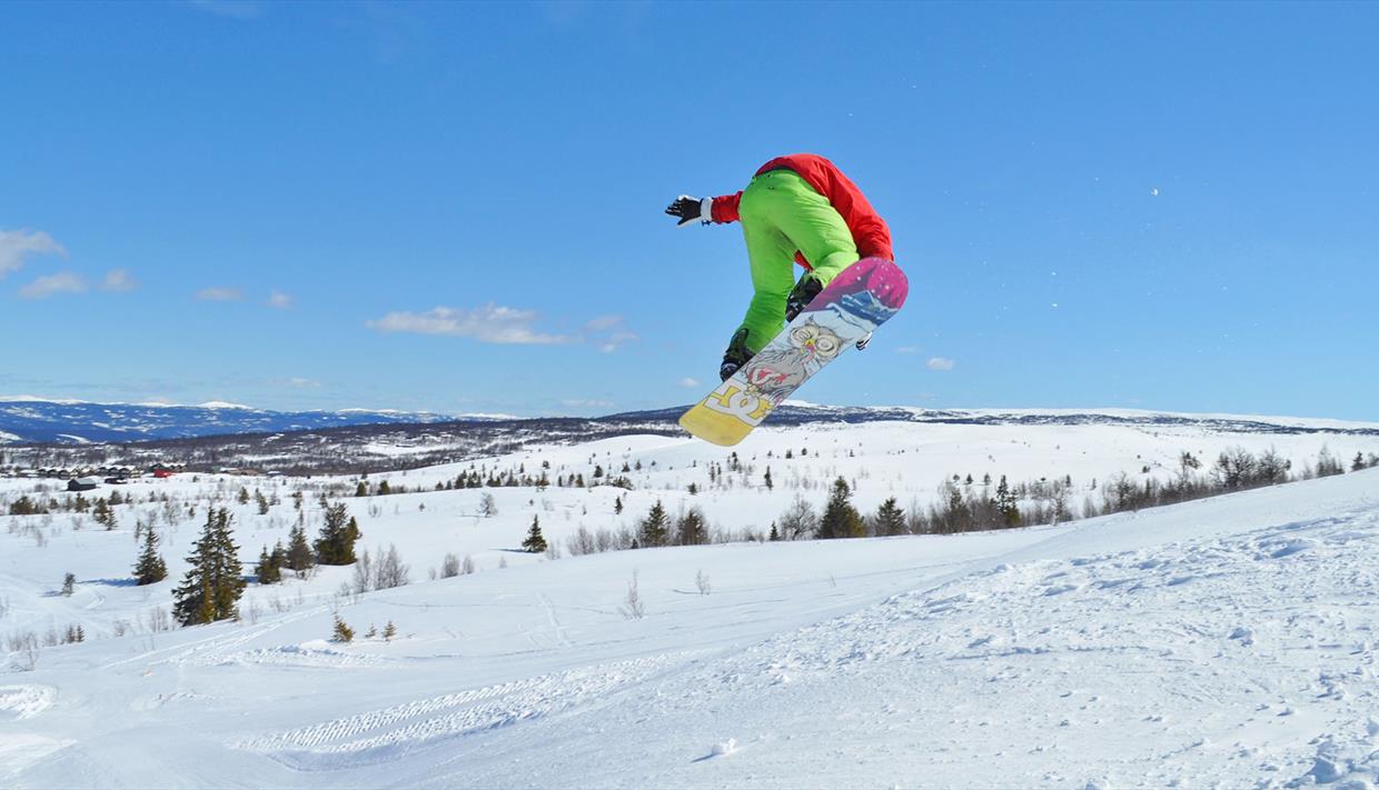 Person jumping on a snowboard