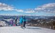 Alpine skiers with a far view at Valdres Alpinsenter in Aurdal.