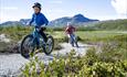 Children cycling the trails of Beitostølen Trail Arrena. Beautiful surroundings with Bitihorn in the background.