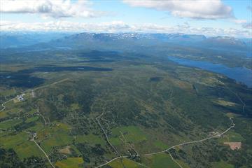 Aerial view of Golsfjellet showing large parts of the mountain road that leads around it. The cycling tour "Golsfjellet rundt" follows this road.