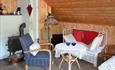 The interior of the living room in traditional Norwegian farm style of the cabin at Kjeldeskogen