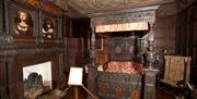 Four poster bed in the bedroom of Bolling Hall Museum.