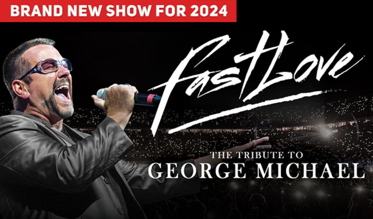 A picture of a George Michael tribute performer in a concert arena