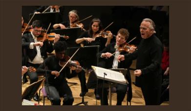 A picture of the Halle Orchestra with conductor Sir Mark Elder