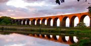 View of Hewenden Viaduct at sunset.