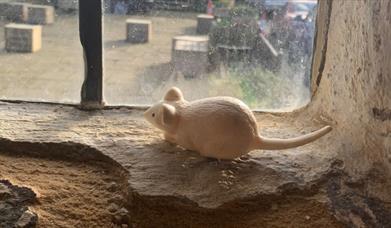 Toy Mouse looking through the window.