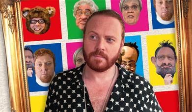 A photograph of comedian Leigh Francis, standing in front of a montage of his characters from Bo' Selecta!