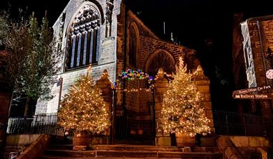 Christmas Trees sparkling on the Main Street steps of the church.