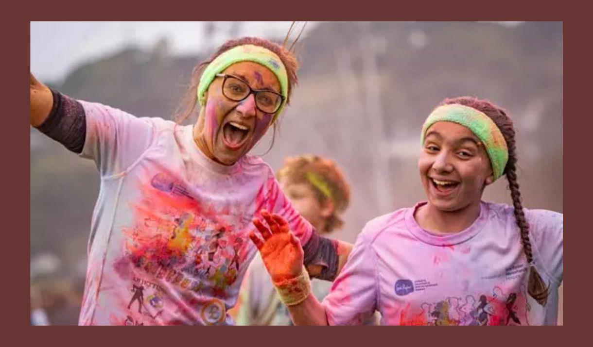 A picture of two participants, covered in coloured paint