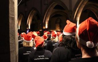 Rock Choir wearing Santa Hats.