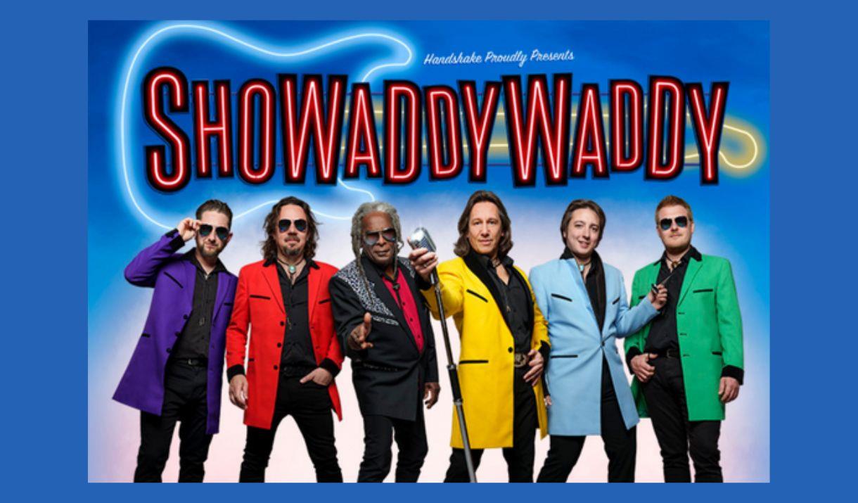A picture if the band Showaddywaddy, all in brightly-coloured jackets. One is holding a microphone