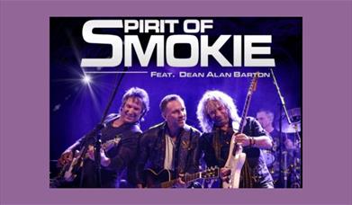 A picture of the band Spirit of Smokie, on a stage, playing guitars