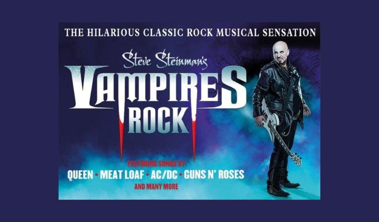 A picture of a man in a leather jacket, holding a guitar. He is snarling, and has fangs. He is standing beside the words Vampires Rock.