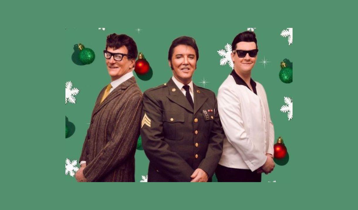 Three men standing together, facing forward, and smiling. One is dressed as Buddy Holly, one as Elvis, and one as Roy Orbison