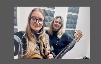 Two ladies with a guitar
