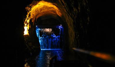 The journey begins, travelling through an underground waterfall