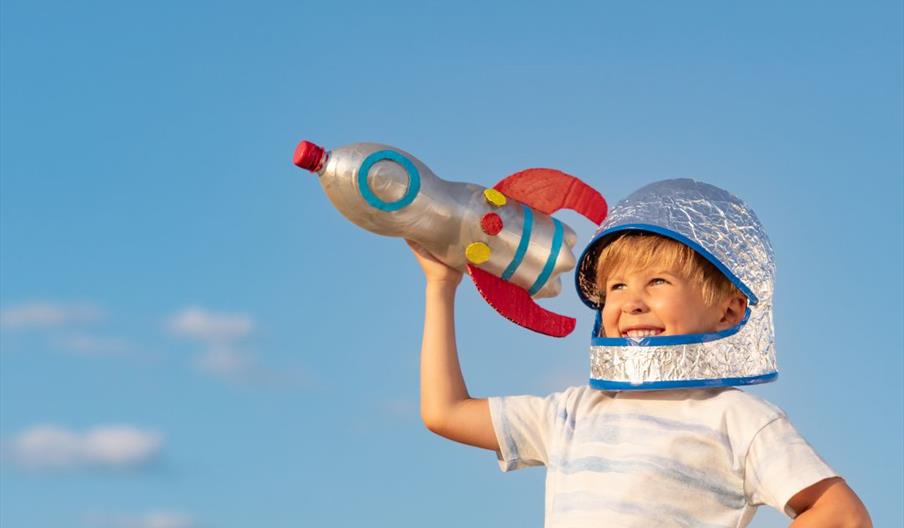 Young child holding a handmade bottlerocket