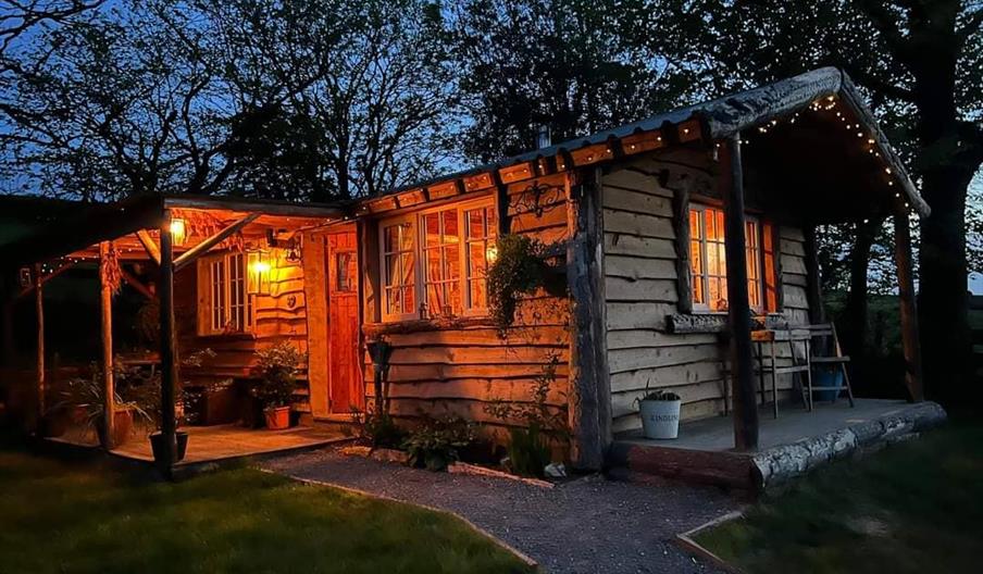 Exterior view of a cabin in Wales. Dog friendly accommodation with hot tub and private garden.
