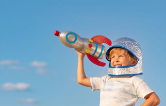 Young child holding a handmade bottlerocket
