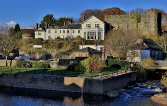 River Usk looking towards remains of Brecon Castle and Brecon Castle Hotel