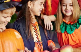 Children carving pumpkins